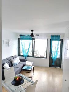 een woonkamer met een bank en een tafel bij Apartment Portonovo Paraiso II - Sea View - Piscina - Wifi - Old Town in Puerto del Carmen