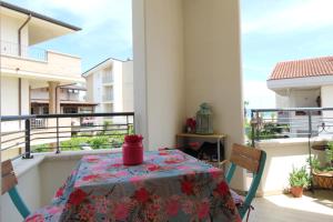 a table on a balcony with a table cloth on it at Solemare in Tortoreto Lido