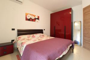a bedroom with a bed and a red cabinet at Solemare in Tortoreto Lido