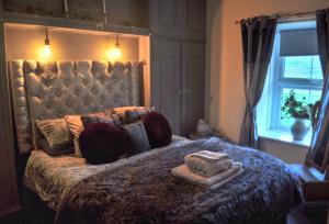 a bedroom with a bed with two towels on it at Peniarth arms in Llanegryn