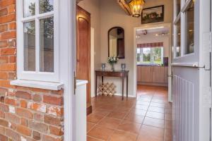 an open hallway with a brick wall and a door at Charming cottage in beautiful countryside with a boating lake - The Calf Pens in Ipswich