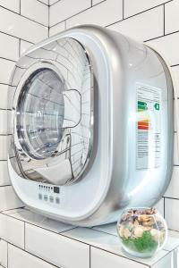 a washing machine on a counter with a bowl of food at GrandWhite Apart in Saint Petersburg