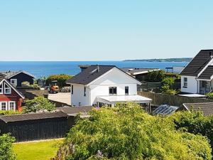 a group of houses with the ocean in the background at 6 person holiday home in Børkop-By Traum in Børkop