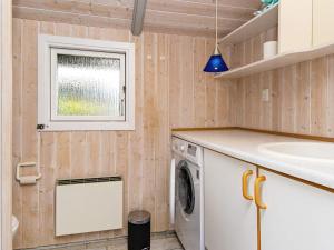 a laundry room with a washing machine and a window at 6 person holiday home in Børkop-By Traum in Børkop +22 photos