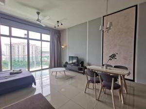a bedroom with a bed and a table and chairs at 11-Modern HOMESTAY PALAZIO lake view Mount Austin Palazio near AEON Themepark Toppen IKEA in Johor Bahru