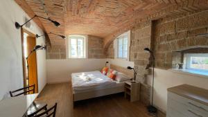 a room with a bed and a brick wall at Penzion Pod Devítkou in Hřensko