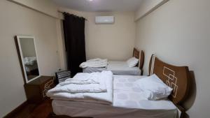 A bed or beds in a room at Alex sea view apartment - families only