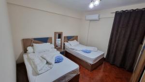 A bed or beds in a room at Alex sea view apartment - families only