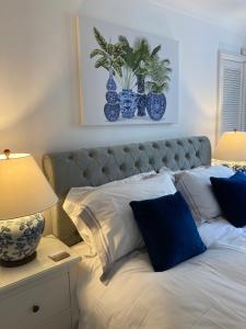 a bedroom with a bed with blue and white pillows at Olive Tree Apartment Hove in Brighton & Hove
