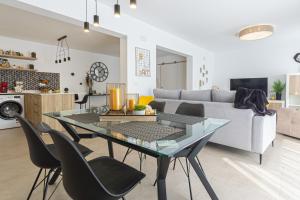 a living room with a glass table and chairs at PÌSO MAR ALTEA in Altea