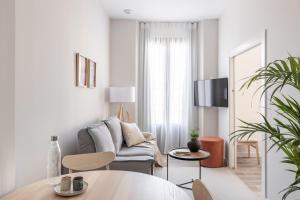 Televízia a/alebo spoločenská miestnosť v ubytovaní Apartamentos Líbere Granada Catedral