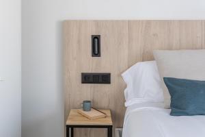 Posteľ alebo postele v izbe v ubytovaní Apartamentos Líbere Granada Catedral