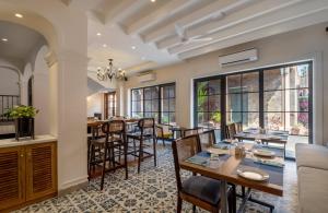 an open kitchen and dining room with a table and chairs at O Pierre in Panaji