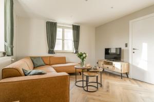 a living room with a couch and a table at De Dommelhoeve in Peer