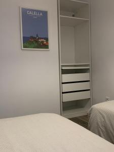 Postel nebo postele na pokoji v ubytování CAN MARTINEZ Calella Beach Boutique Apartment