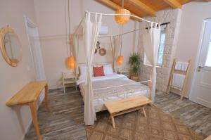 a bedroom with a canopy bed in a room at Hera Hotels Alaçatı in Cesme