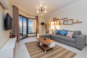 a living room with a couch and a tv at Matarma Beach Residence in Ras Sedr