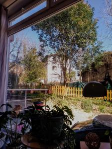 a window view of a yard with a house at Balea Hostel in San Sebastián