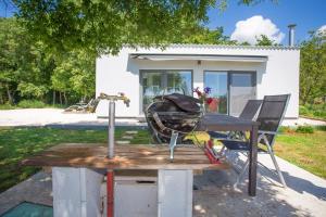 a picnic table with a helmet on it in front of a house at Cottage House Loborika with Pool in Loborika
