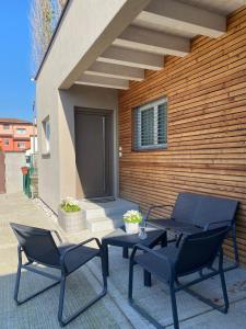a patio with two chairs and a table and a building at CASA MARLU in Vicenza