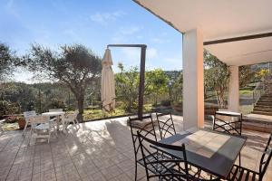 a patio with a table and an umbrella at Le Mimose Bilo4 in Imperia