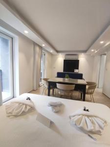 a bedroom with a bed and a dining room with a table at The G Hotel by JL in St Julian's