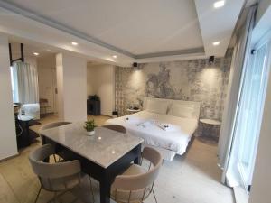 a bedroom with a bed and a table and chairs at The G Hotel by JL in St Julian's