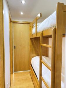 a bunk room with two bunk beds and a closet at Au cœur de Cauterets, joli duplex de 55m² in Cauterets