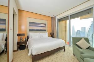 a hotel room with a bed and a couch at FAHH Lovely Studio at Emaar Fashion Avenue in Dubai
