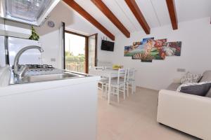 a kitchen and living room with a sink and a couch at La dimora di Venere in Agerola