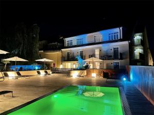 a building with a swimming pool at night at Hotel Stainzerhof in Stainz