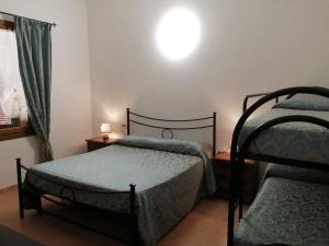 A bed or beds in a room at Vecchio Faro Residence