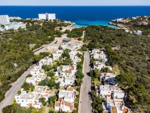 an aerial view of a town with the ocean at Club Cala Domingos in Calas de Mallorca