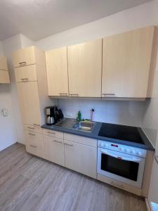 a kitchen with a sink and a stove top oven at strandnahe 3-Zimmer Wohnung direkt am Yachthafen in Kiel