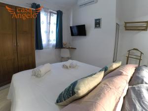 Posteľ alebo postele v izbe v ubytovaní Casa Angelo B&B