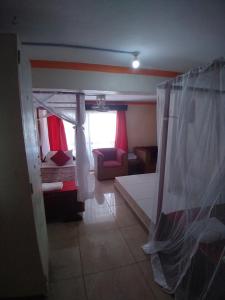 a room with a bedroom with a bed and a window at Ocean View Nyali Boutique Hotel in Nyali