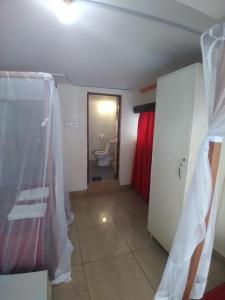 a room with a bathroom with a toilet and a door at Ocean View Nyali Boutique Hotel in Nyali