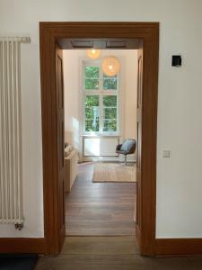 an open door into a room with a window at 1-2 Zimmer in alter Villa - Netflix+Homeoffice in Bergkamen