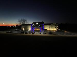 a building with purple lights in a parking lot at night at Budgetel Inns & Suites in Fairfield