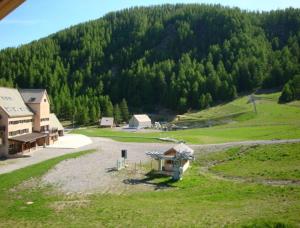 an aerial view of a field with a house and a mountain at Boost Your Immo Aurans Réallon 221A in Réallon