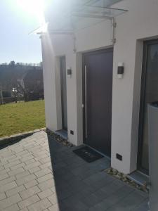 a row of doors on the side of a building at Ferienwohnung am Felsenkeller in Ebrach