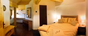 a bedroom with a bed and a bathroom with a tub at Villa Mischa in Grashtitsa