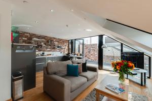 a living room with a couch and a table at Base Serviced Apartments - Sir Thomas Street in Liverpool