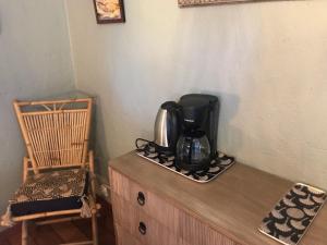 a coffee maker sitting on top of a wooden cabinet at La chambre de Toutou in Bastia