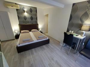 A bed or beds in a room at Palma Vendégház