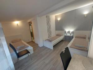 A bed or beds in a room at Palma Vendégház