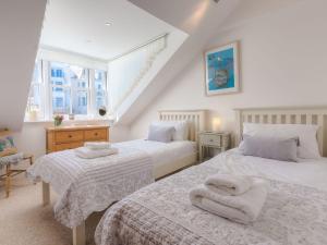 a bedroom with two beds with towels on them at Alfred Wallis in St Ives