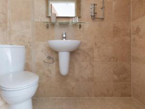 a bathroom with a toilet and a sink at Alfred Wallis in St Ives
