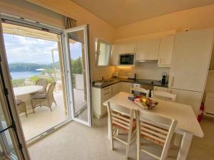 a kitchen with a table and a view of the ocean at Paleopetres K-Three - Premium Double Suite - Kalami - in Kalami