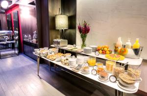 a buffet of food on a table in a restaurant at Esplendor Plaza Francia in Buenos Aires